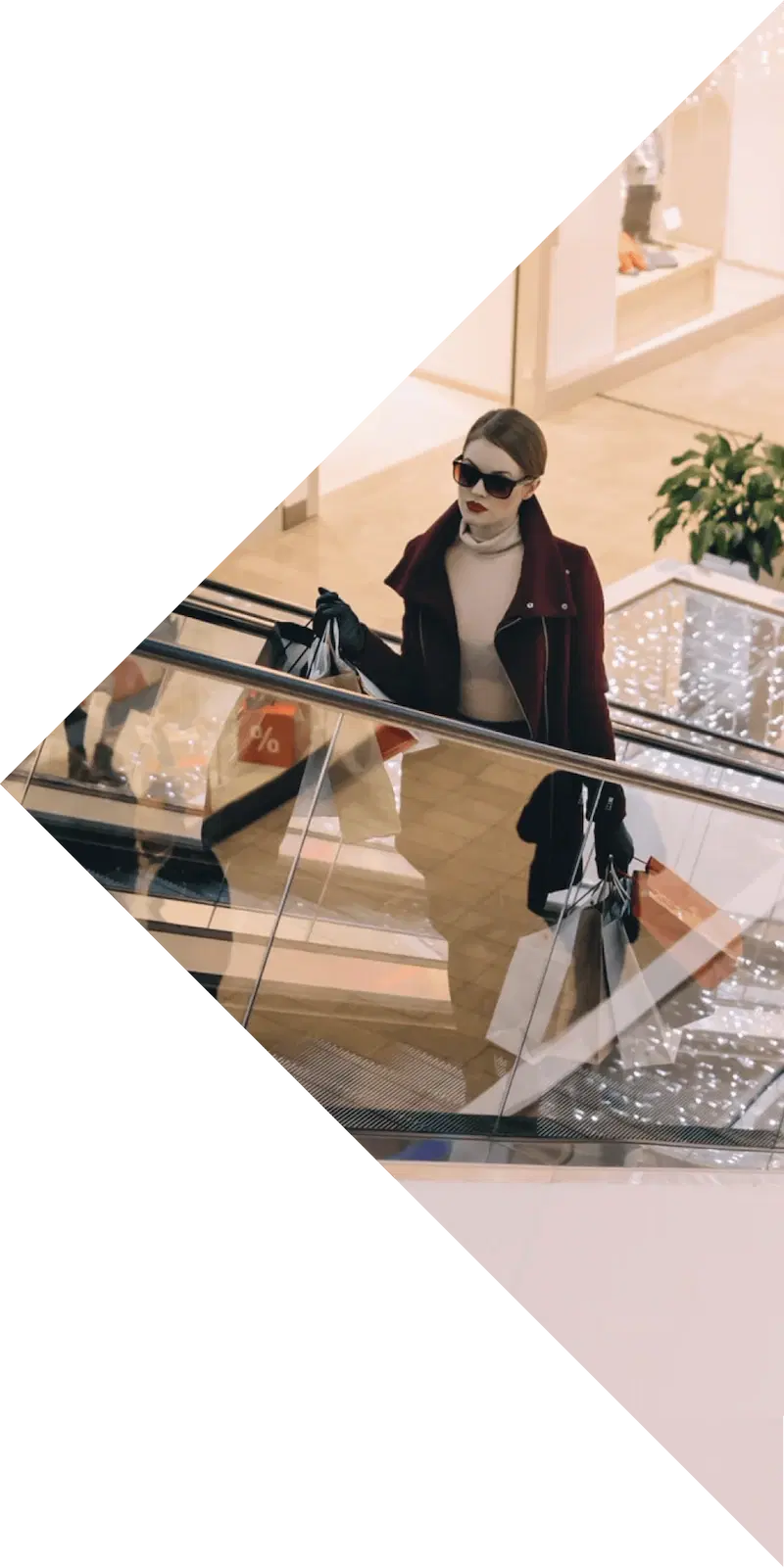 Woman with shopping bags on a shopping-centre escalator